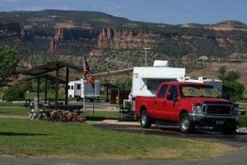 A truck and camper parked by a gazebo in James M. Robb State Park.